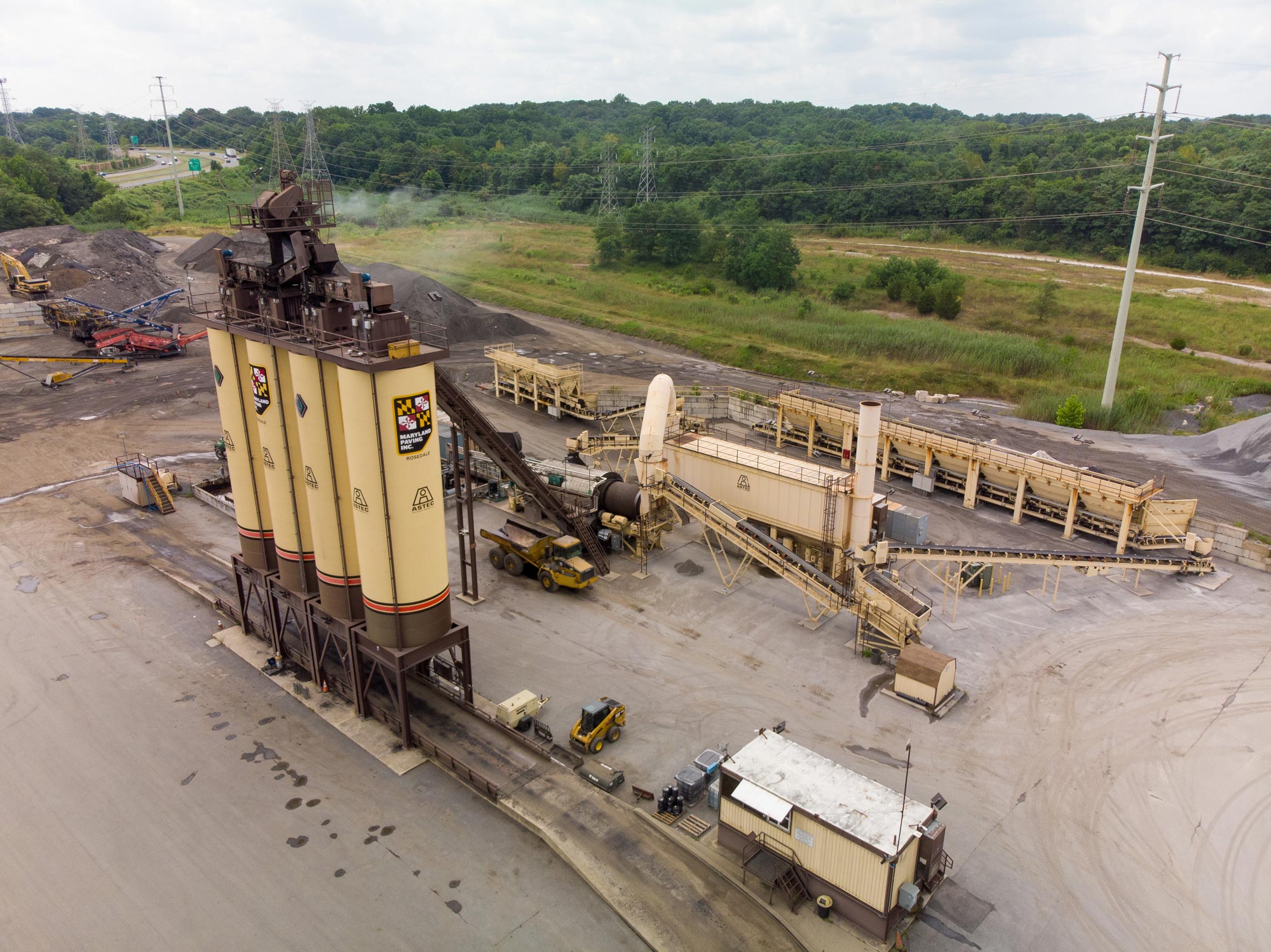 Large asphalt storage silos at a paving plant located in maryland, owned and operated by Gray & Son a leading site and development contractor in Maryland.