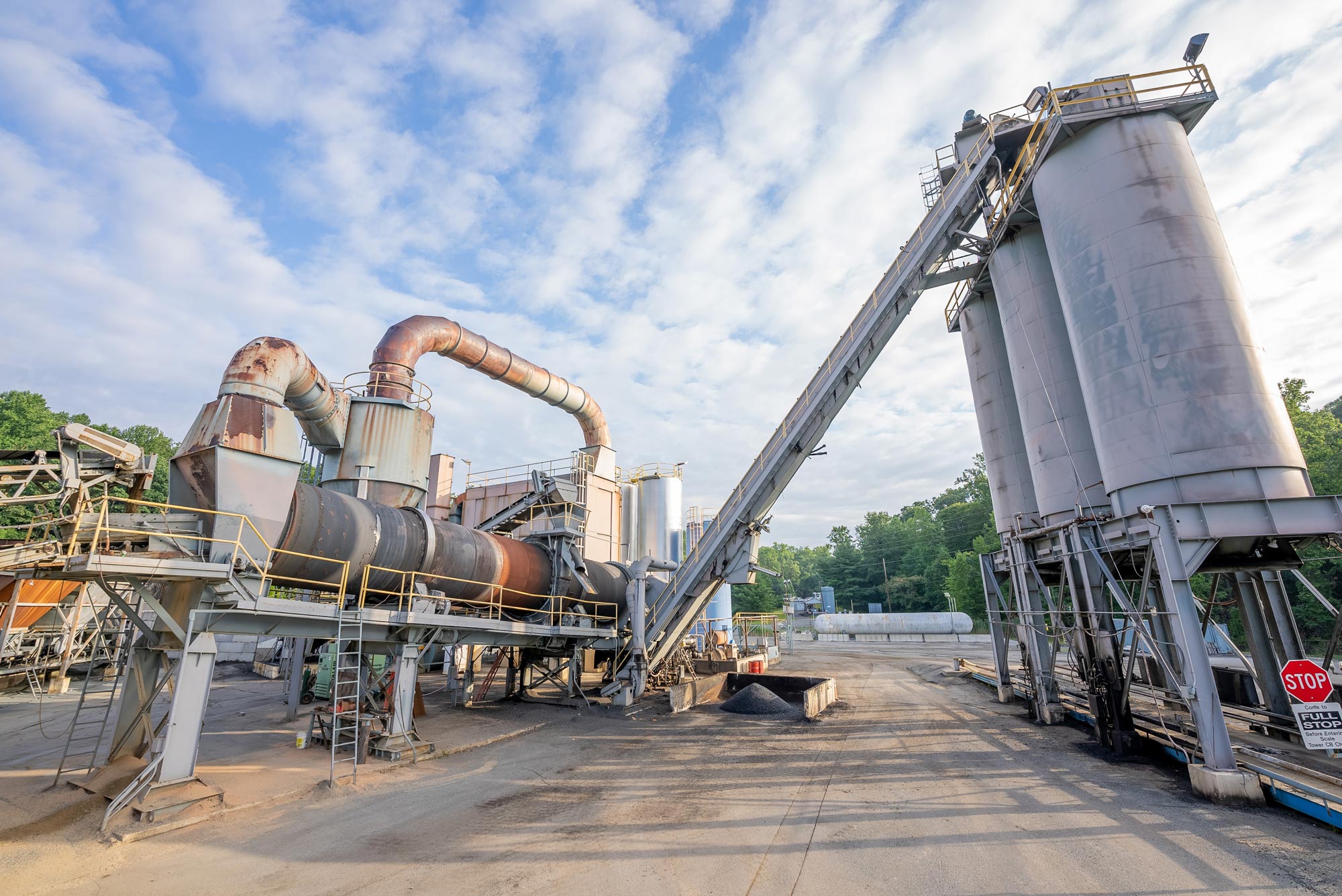 Large asphalt storage silos at a paving plant located in maryland, owned and operated by Gray & Son a leading site and development contractor in Maryland.