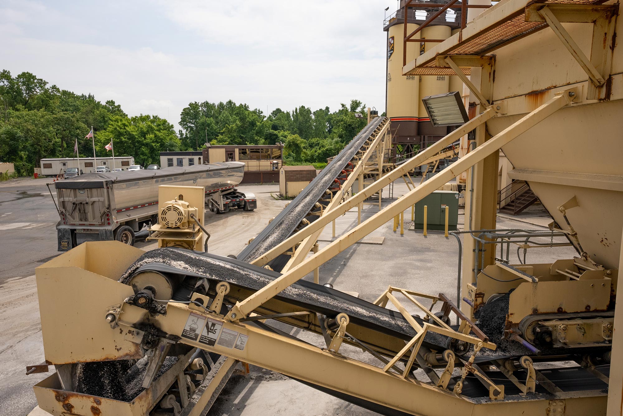 An asphalt conveyor belt transporting asphalt located at an asphalt storage site owned and operated by Gray & Son a leading site and development contractor in Maryland.