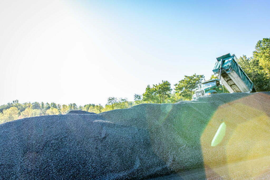 A green dump truck owned and operated by Gray & Son, a leading site contractor in Maryalnd