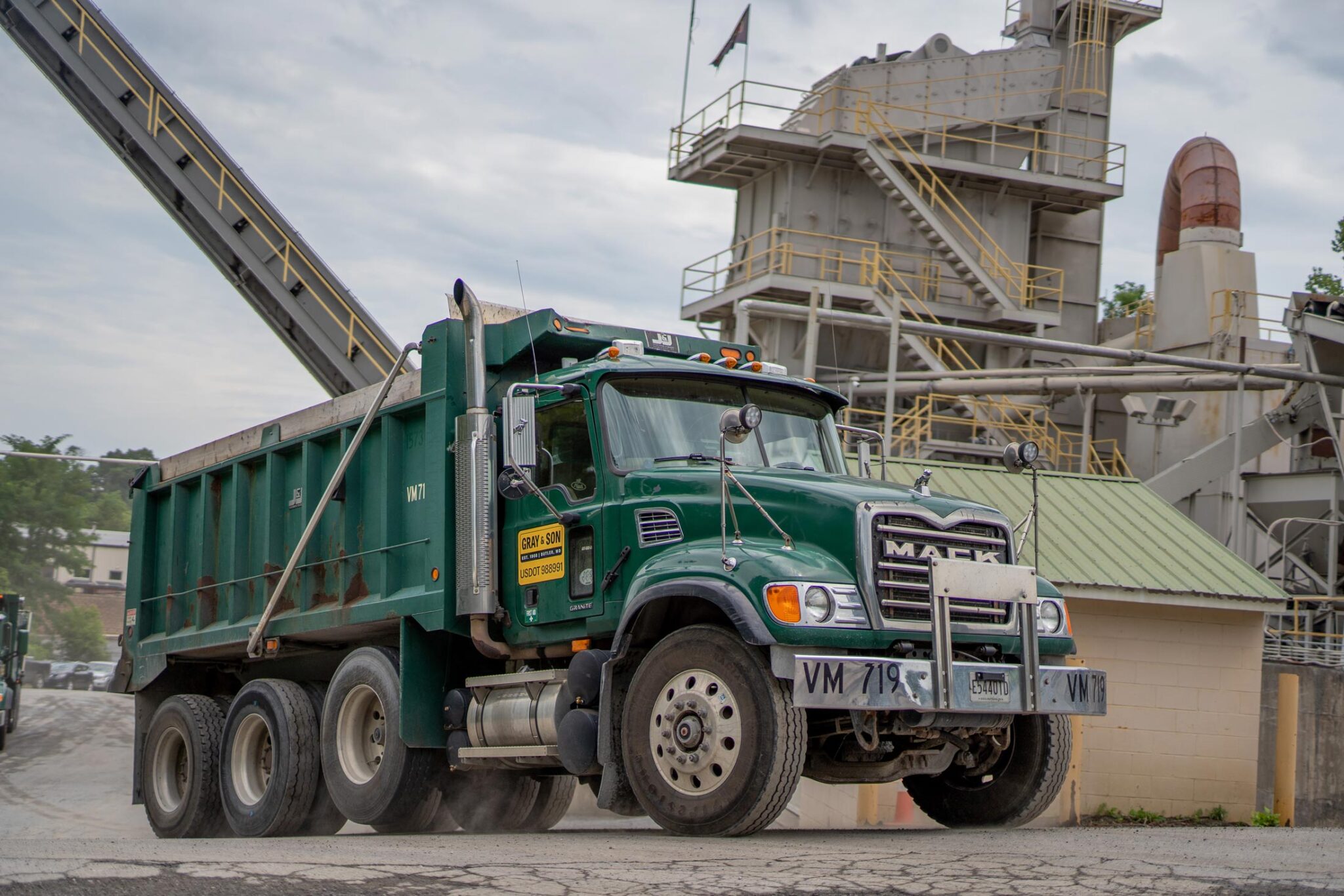 A green construction mack truck owned by Gray & Son a leading site and development contractor in Maryland.