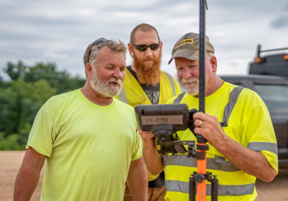 Three construction workers, working together for a company called Gray & Son a leading site and development contractor in Maryland.